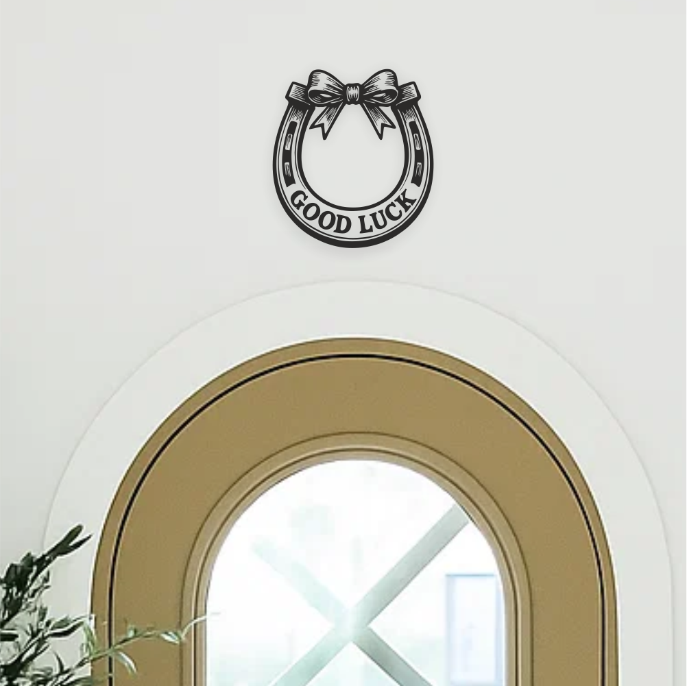 Close-up view of good luck horseshoe vinyl decal in upwards orientation — catching luck above doorway. Black air-release vinyl wall sticker