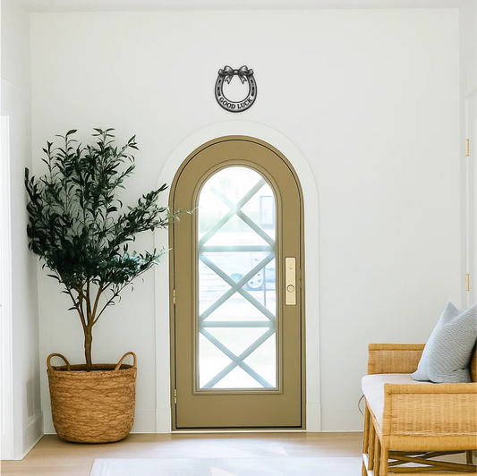 Good luck horseshoe wall decal applied above hallway door — upwards orientation (catching luck). Stylish hallway wall decor in classic black vinyl