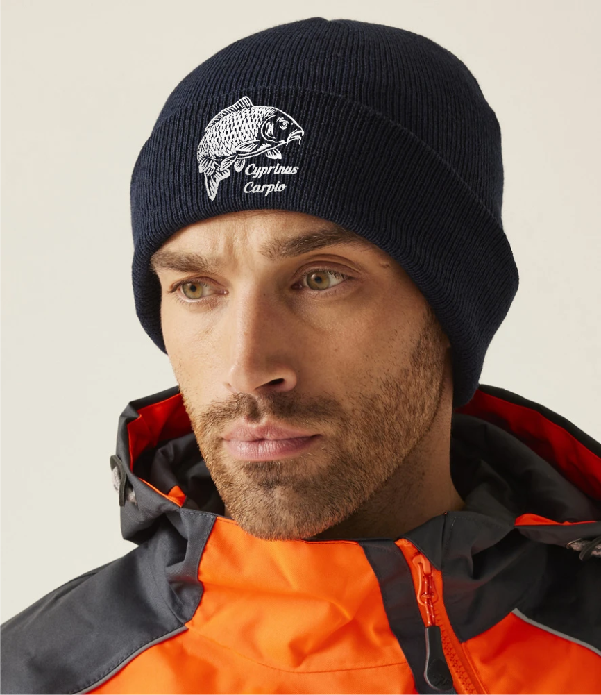 Black fishing beanie with embroidered carp logo – worn by model in outdoor setting