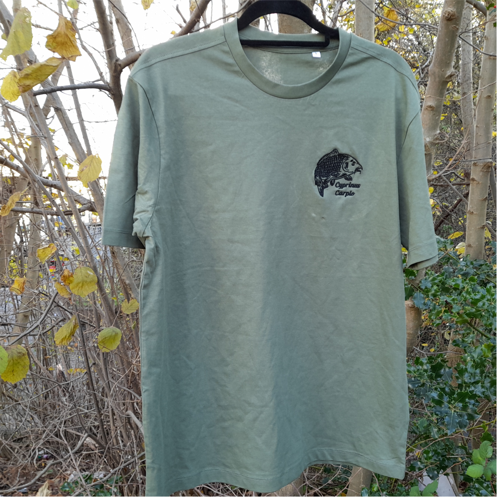 Earthy green carp fishing T-shirt on hanger outdoors – embroidered carp angler clothing