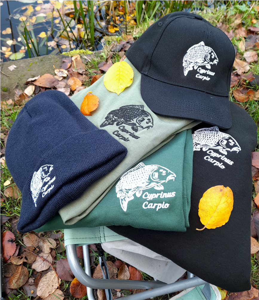 Fishing apparel bundle with embroidered carp cap, beanie and hoodies displayed outdoors