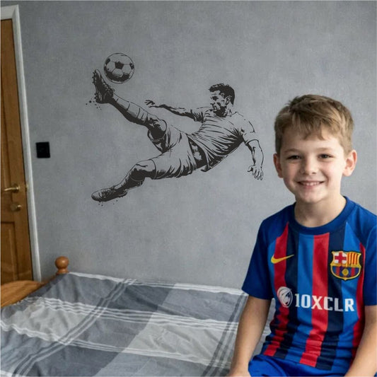 Boy smiling in bedroom with football bicycle kick wall decal – dynamic kids room wall decor