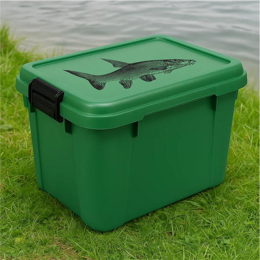 Green plastic fishing storage box with black barbel fish decal – placed on grass by the lake